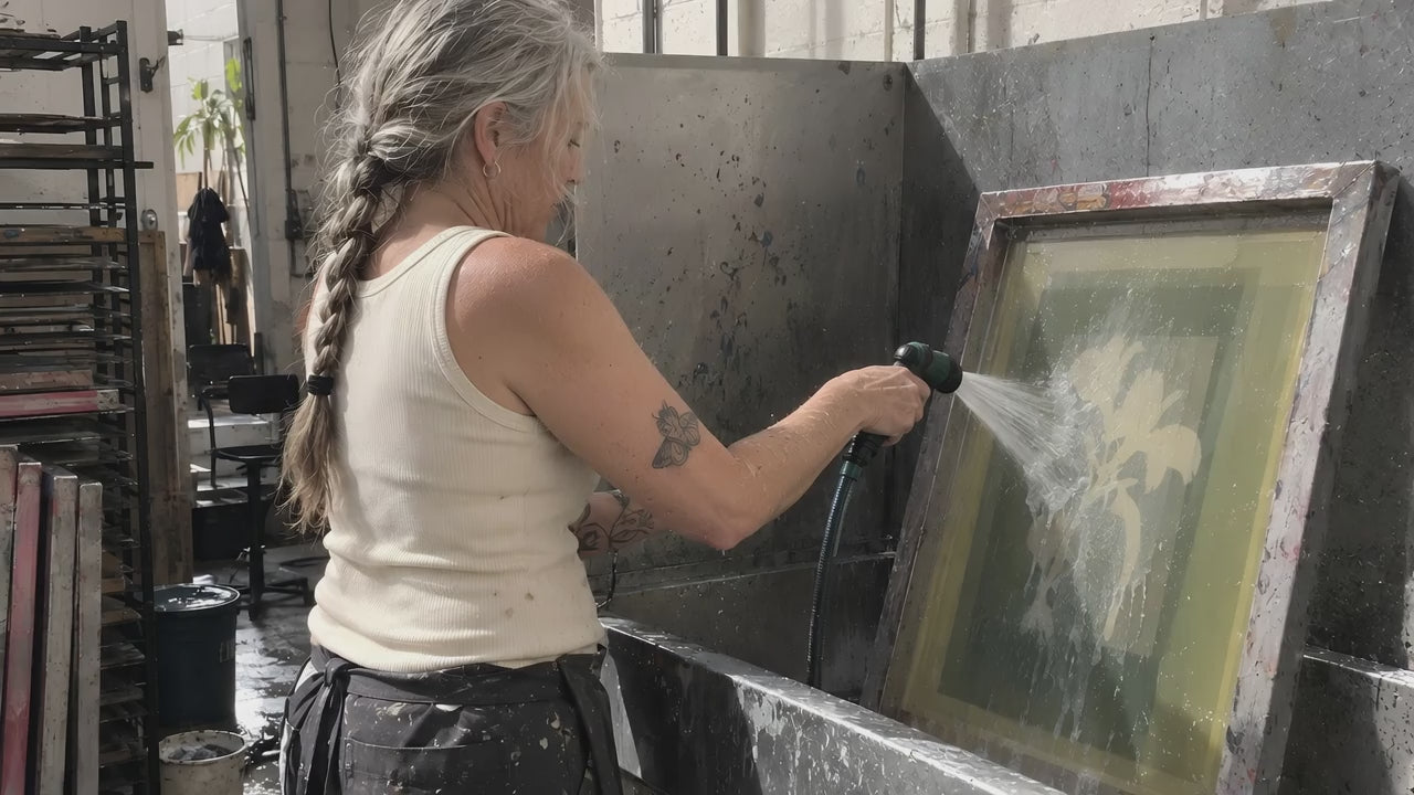 A printer in a bone ENVY Tank hosing ink off a screen in the wash-out booth