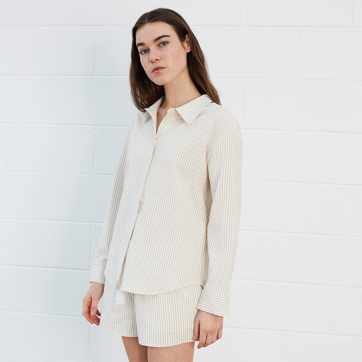 Woman wearing striped shirt and shorts