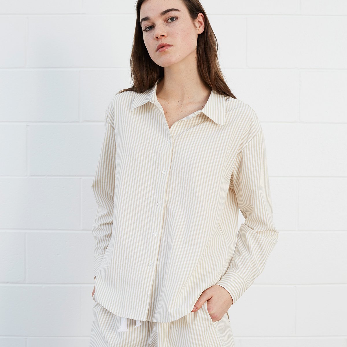 Woman wearing striped shirt and shorts