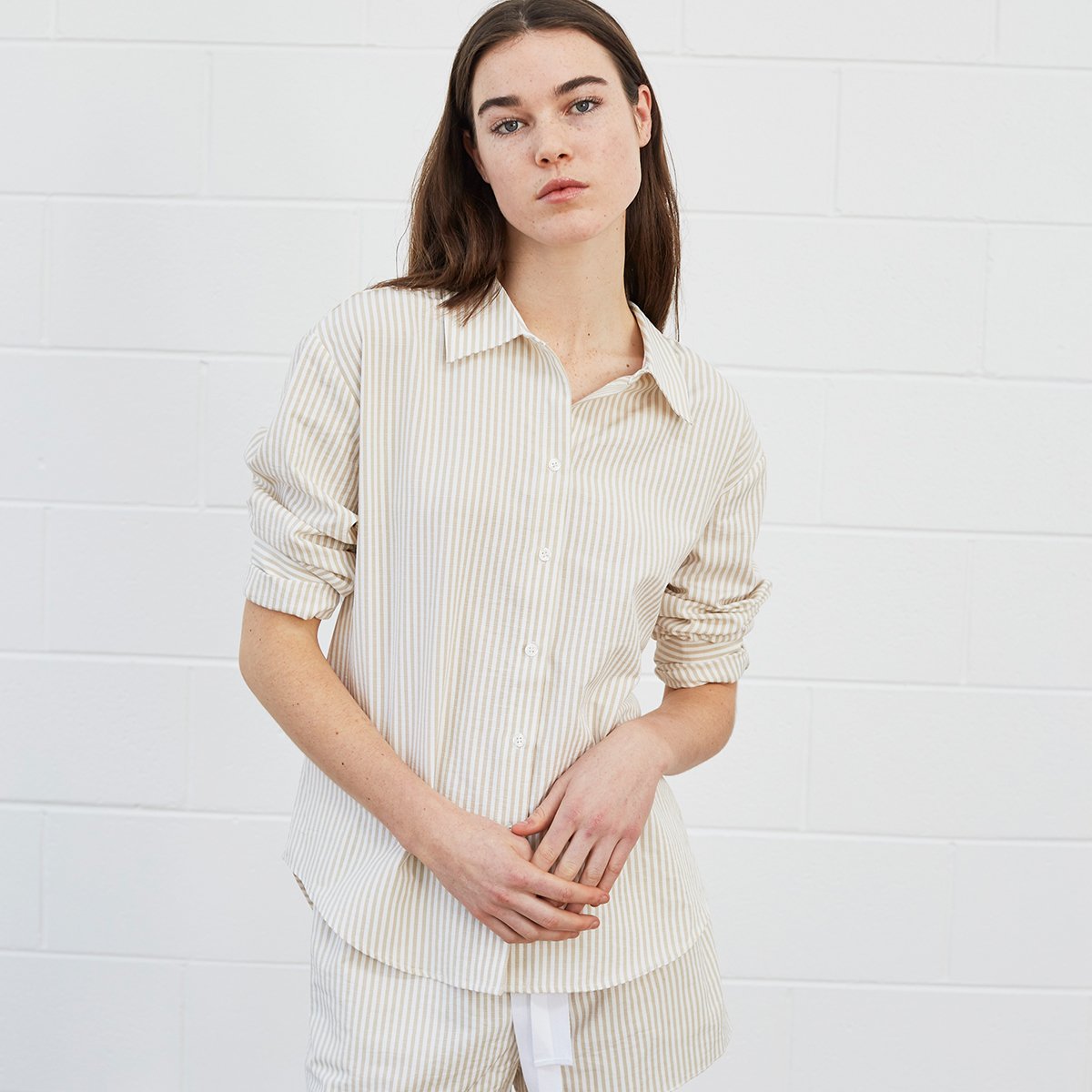 Woman wearing striped shirt and shorts