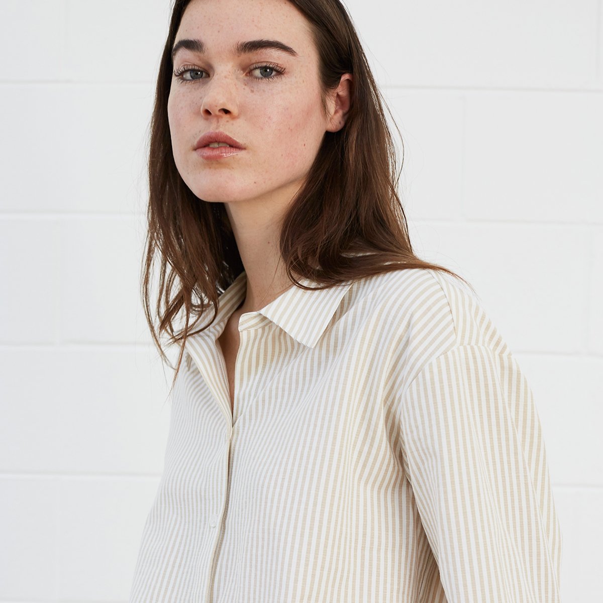 Woman wearing striped shirt and shorts