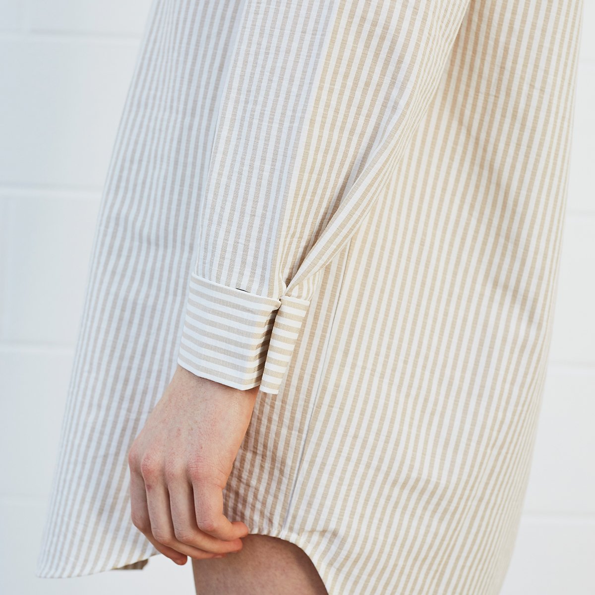 Woman wearing striped shirt dress 