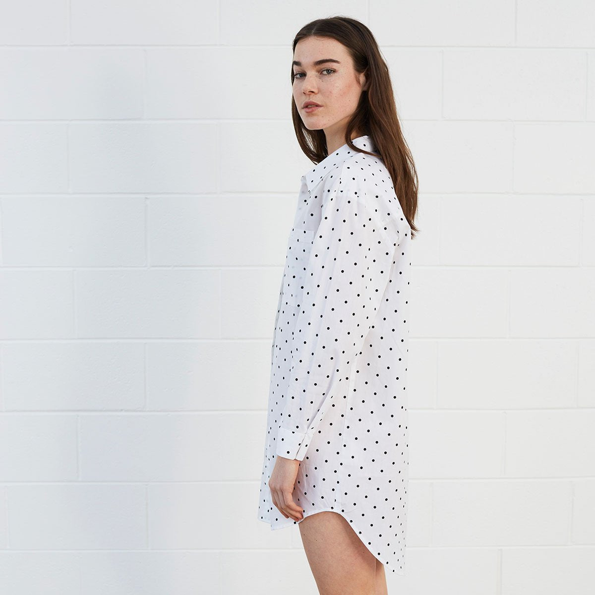 Woman wearing polka dot shirt dress