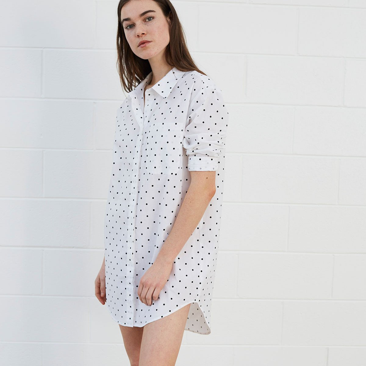Woman wearing polka dot shirt dress