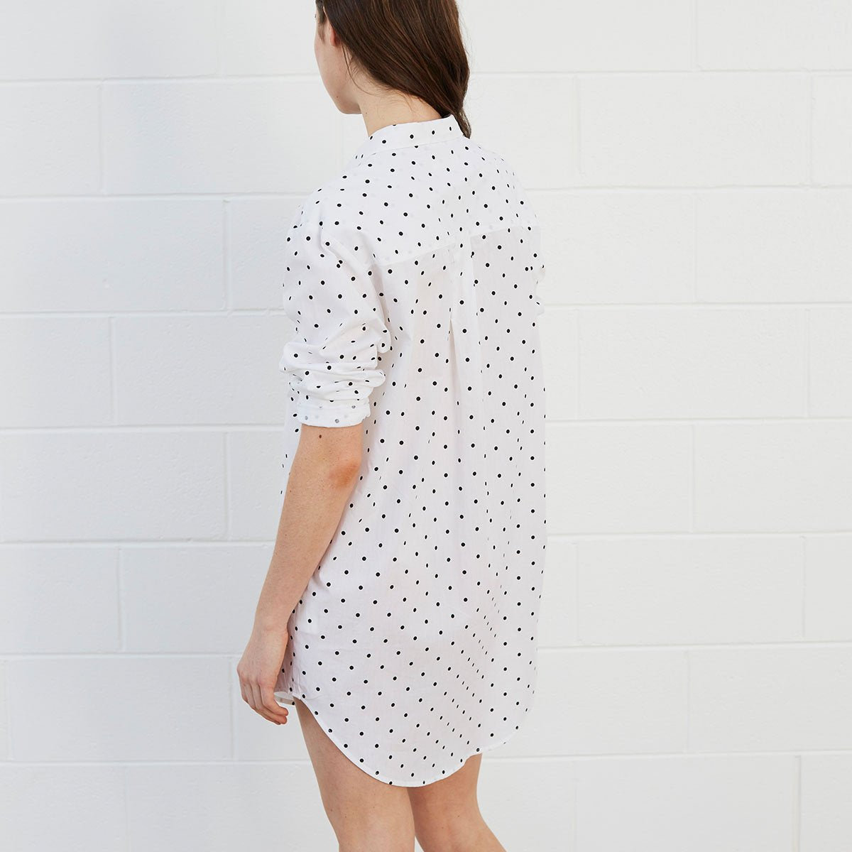 Woman wearing polka dot shirt dress