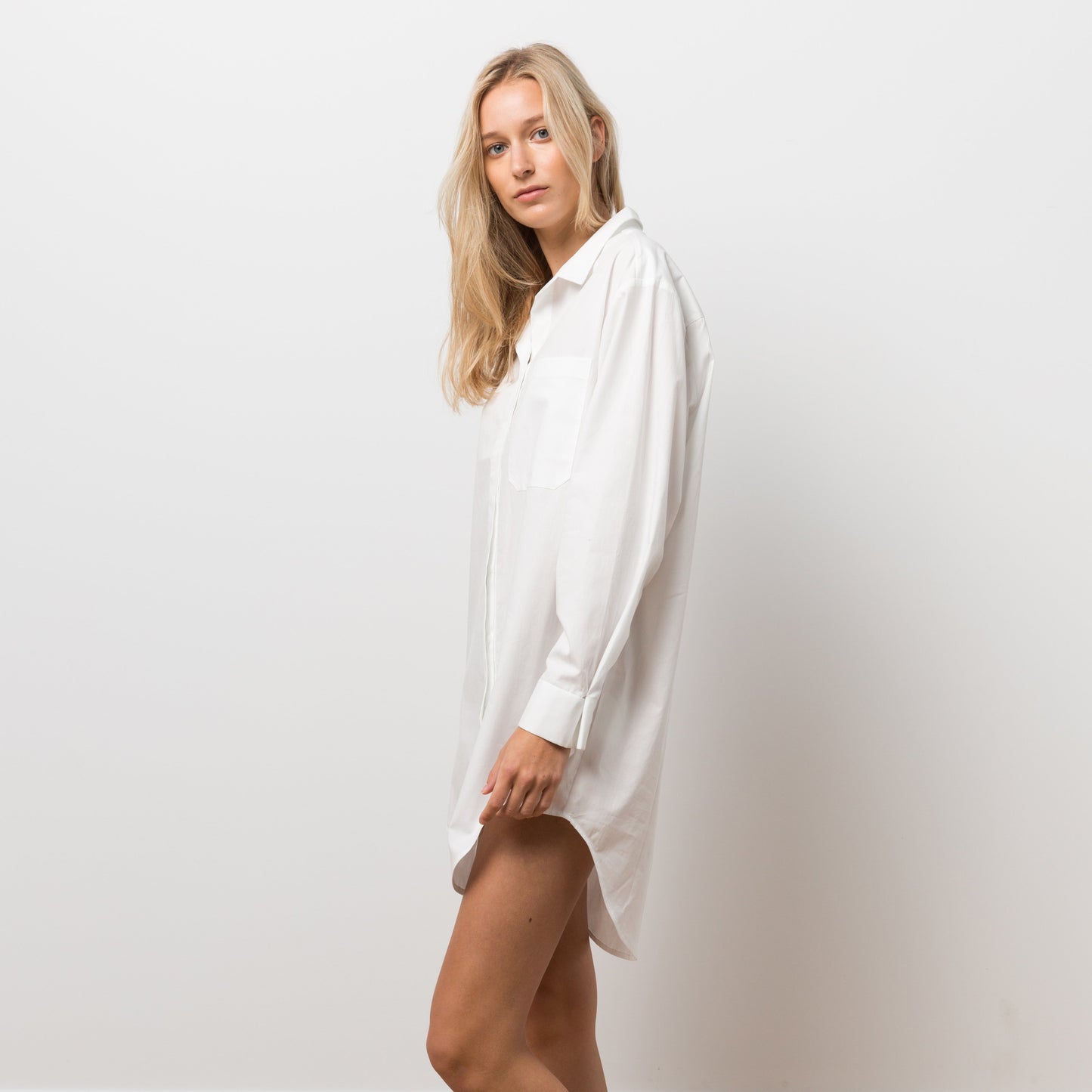 Woman wearing white shirt dress