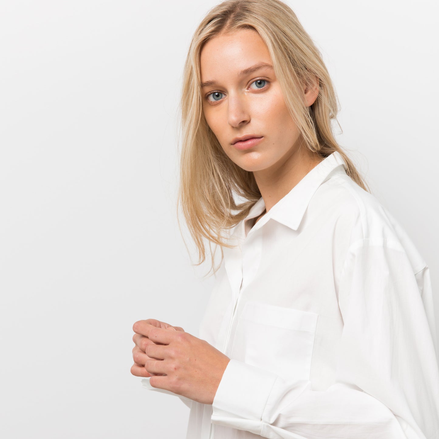 Woman wearing white shirt dress